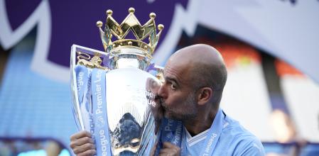 Manchester City's head coach Pep Guardiola celebrates with the Premier League trophy after the English Premier League soccer match between Manchester City and West Ham United at the Etihad Stadium in Manchester, England, Sunday, May 19, 2024. Manchester City clinched the English Premier League on Sunday after beating West Ham in their last match of the season. (AP Photo/Dave Thompson)